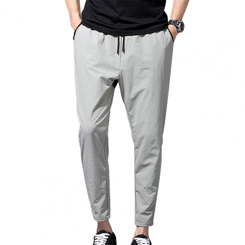 Modernas vīriešu devītās bikses, aukliņas kabatas, mīksta auduma elastīga jostasvietas zīmuļu bikses