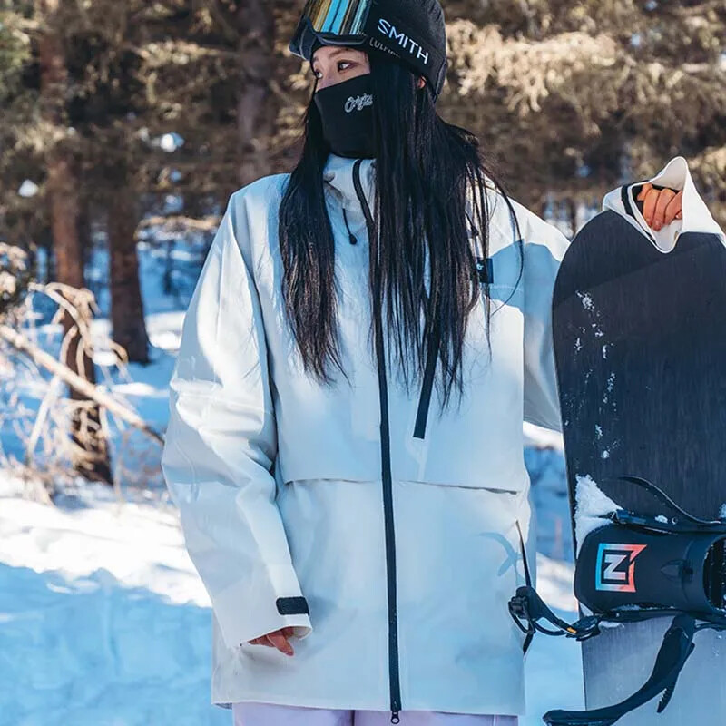 2025. gada jauna ziemas cietā slēpošanas jaka āra slēpošanai sievietēm vīriešiem, vēja necaurlaidīga, ūdensnecaurlaidīga, elpojoša pieaugušo slēpošanas jaka Sniega mēteļi ar kapuci