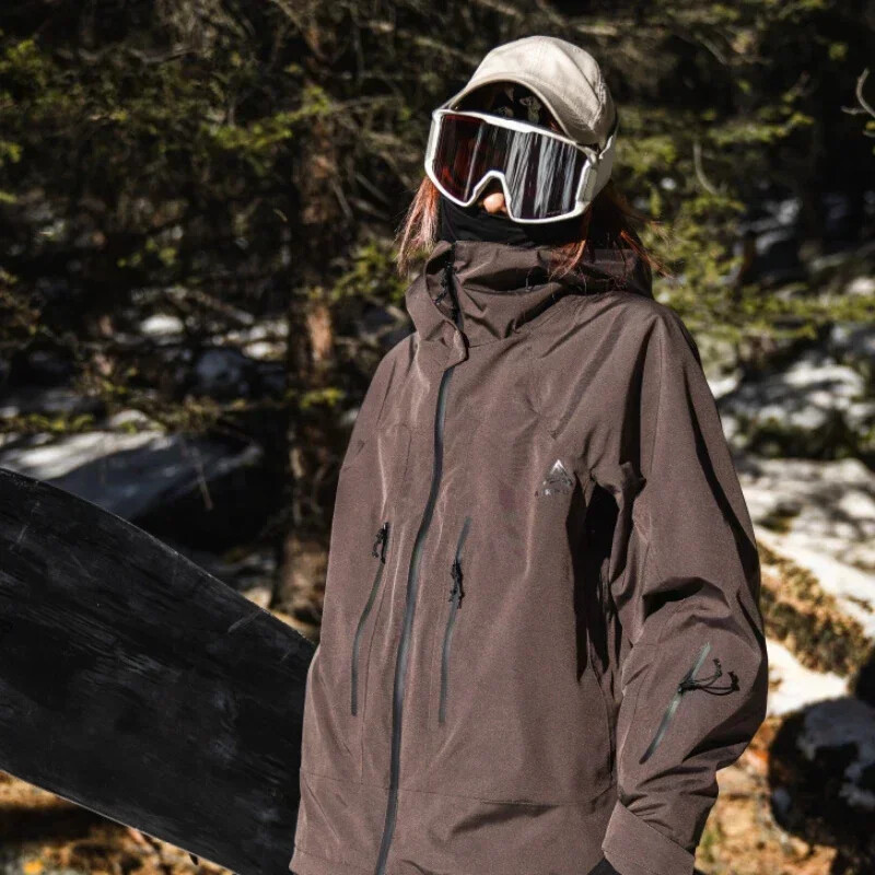 Jauna 2025. gada āra sporta slēpošanas jaka Vīriešu sieviešu ūdensnecaurlaidīgs vēja necaurlaidīgs slēpošanas apģērbs Topi ar kapuci ziemas silts snovborda treniņtērps