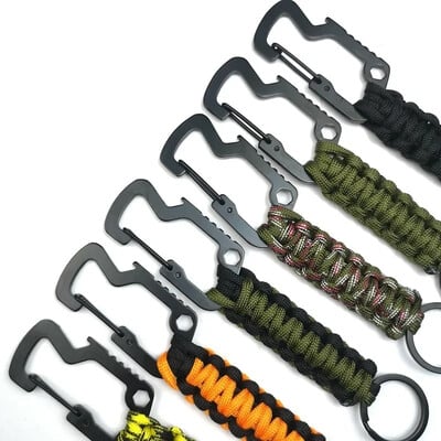 Paracord atslēgu piekariņš, militārs pīts Paracord atslēgu piekariņš āra daudzfunkcionāls izdzīvošanas avārijas mezgla pudeļu attaisāmais sešstūra uzgriežņu atslēgas rīks