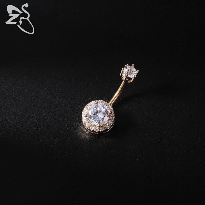 Piercing do pupka z nehrdzavejúcej ocele 14G zlatej farby s hadím srdcom a lesklým CZ krištáľom v tvare motýľa.