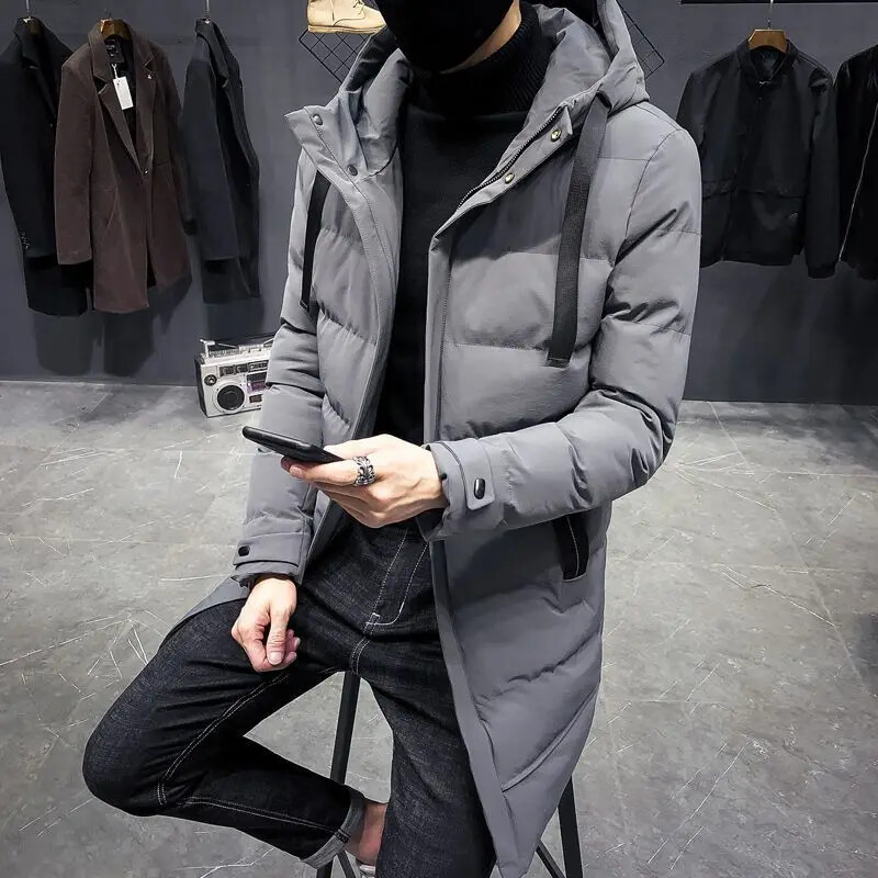 Ziemas vīrietis pagarina kokvilnas mētelis dūnu jaka vidēja garuma pāri ceļgaliem sabiezina jauniešu kapuci vaļīga, saglabā siltumu. Temperaments Vienkāršs