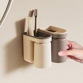 Daudzfunkcionāls zobu birstes statīvs Bez štancēšanas pie sienas stiprināms mutes skalošanas trauks Zobu birstes krūze Vannas istabas uzglabāšanas plaukta turētāja piederumi