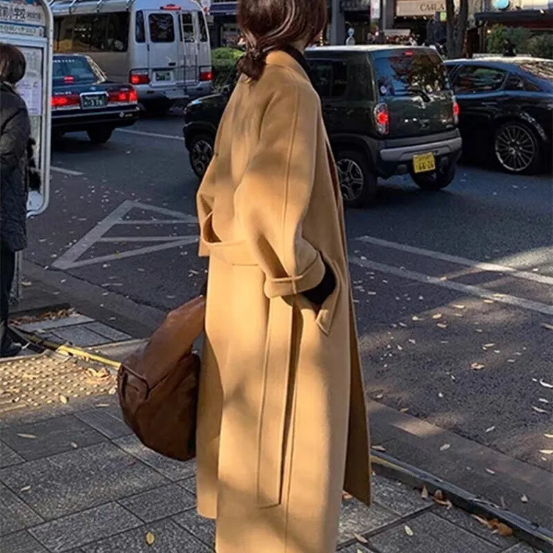 Vilnas mētelis 2024. gada pavasarī un rudenī jauns stils, moderns elegance korejiešu izdevums, brīvs vidēja garuma siksniņa sieviešu vilnas mētelis