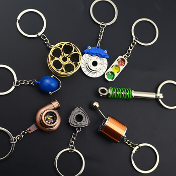 Creative Gear Head Keychain Скоростна скоростна кутия Ключодържател за автомобилен ключ Turbo Hub Спирачен диск Висулка Амортисьор Ключове Държач Пръстен за верига