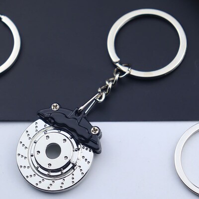 Auto modeļa atslēgu piekariņš, ķivere ar turbopūti, amortizators, bremžu disks, mugursoma, kulons, auto apdare