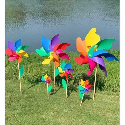 Spalvingo vėjo malūno lauko dekoravimo festivalio vaizdingas parkas, vaikai laiko besisukantį medinį spalvotą vėjo malūną