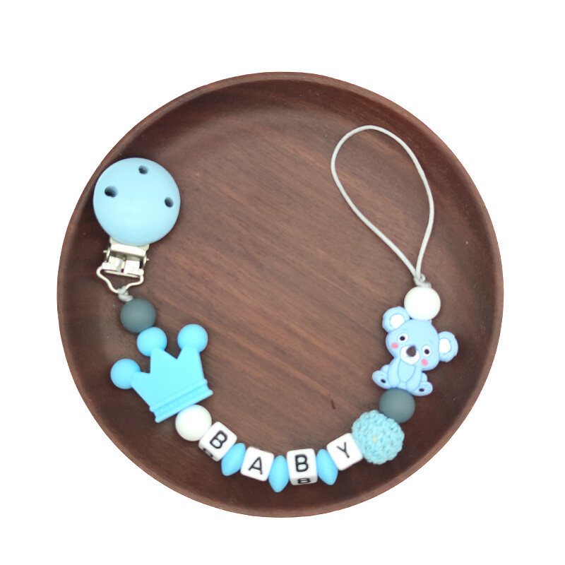 Ar rokām darināta silikona zīdaiņu koka manekena knupja piespraudes droša zobu ķēdīte.