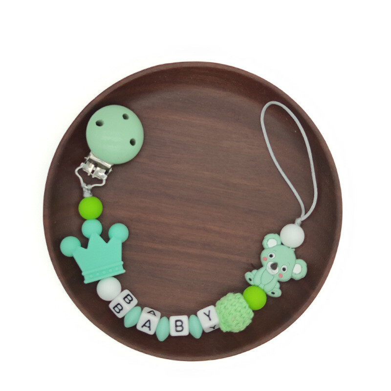 Ar rokām darināta silikona zīdaiņu koka manekena knupja piespraudes droša zobu ķēdīte.