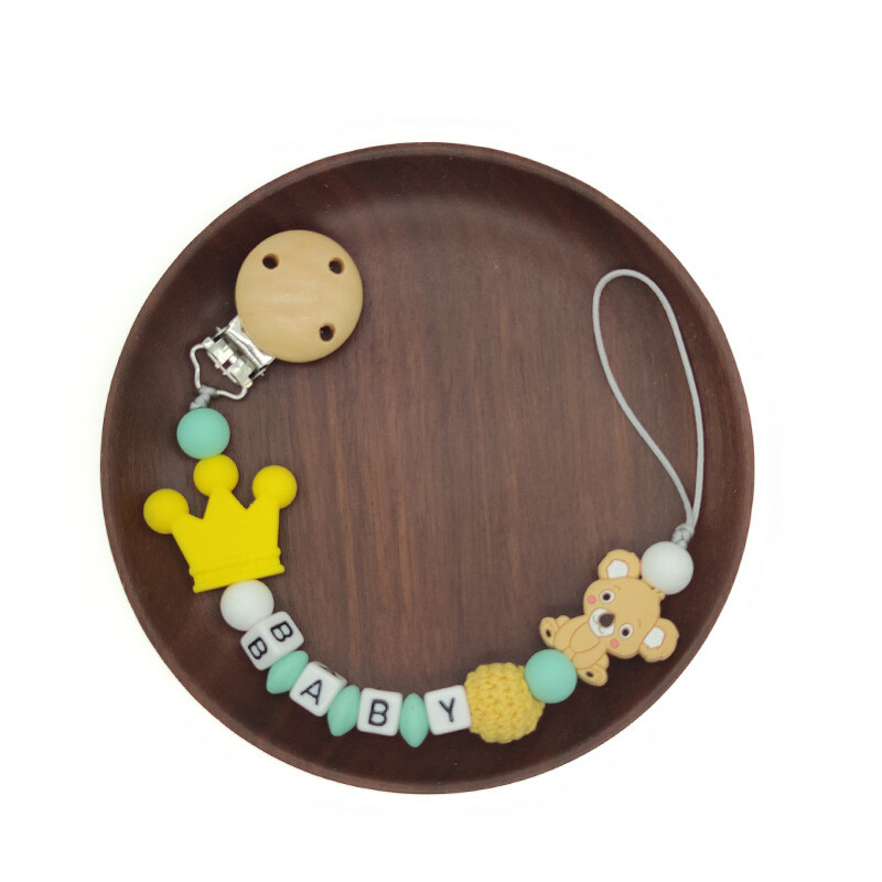 Ar rokām darināta silikona zīdaiņu koka manekena knupja piespraudes droša zobu ķēdīte.