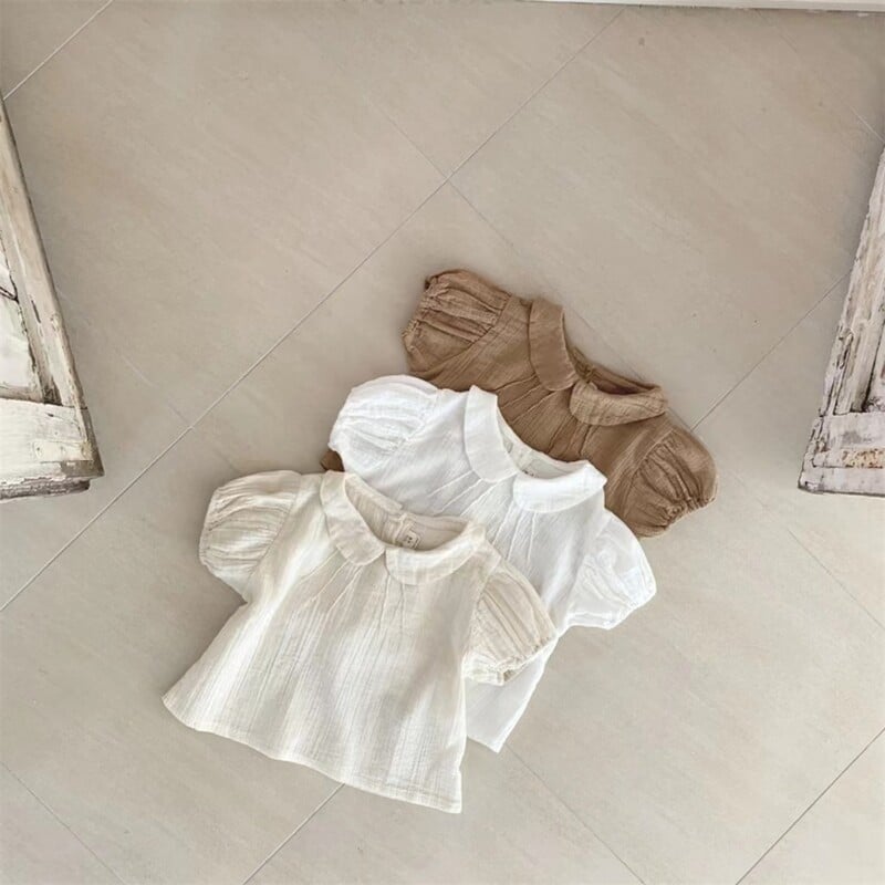 2025. gada vasara Jauna mazuļu meiteņu vienkrāsaini krekli ar piedurknēm Kokvilnas zīdaiņu T krekli Toddler Ikdienas atloks Krekli Bērnu apģērbi