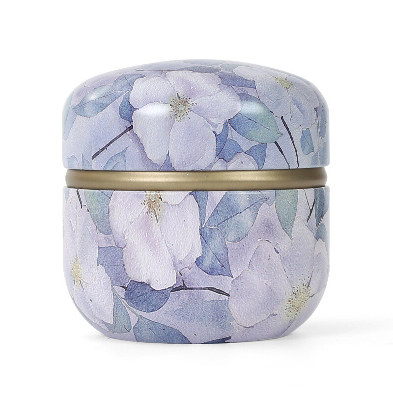 Skārda tējas kastes mājsaimniecības aizzīmogotās tējas iepakojuma kaste pārnēsājamas japāņu stila ziedu tējas mazas apaļas skārda kastes