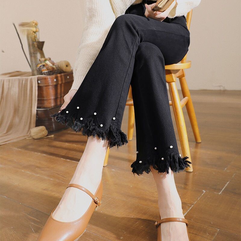 Crne traperice s raširenim rubom za žene za proljeće i jesen 2022., nove elastične uske hlače s devet točaka i neobrađenim rubom, visoki struk, raširene hlače