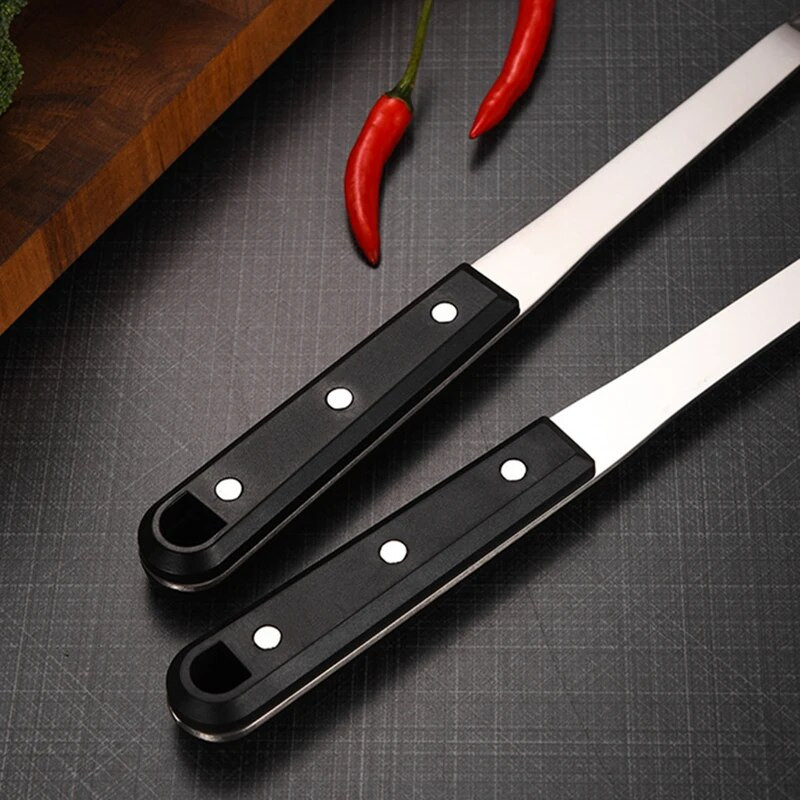 Ēdienu gatavošanas rīku komplekts ar melnu rokturi Nerūsējošā tērauda cepšanas lāpstiņa zupas karote Mājas pārtikas lāpsta Caurduris Jauni virtuves piederumi