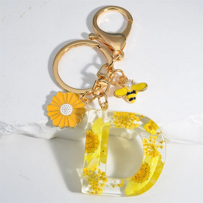 Χαριτωμένο τεχνητό μενταγιόν μαργαριτάρι μελισσών 26 γράμματα Μπρελόκ Μόδα μαργαρίτα με λουλούδι μπρελόκ με ρητίνη Γυναικεία ανδρική τσάντα αυτοκινήτου Γραφικό στοιχείο τηλεφώνου