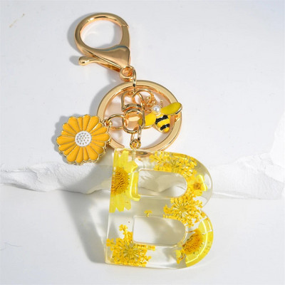 Χαριτωμένο τεχνητό μενταγιόν μαργαριτάρι μελισσών 26 γράμματα Μπρελόκ Μόδα μαργαρίτα με λουλούδι μπρελόκ με ρητίνη Γυναικεία ανδρική τσάντα αυτοκινήτου Γραφικό στοιχείο τηλεφώνου