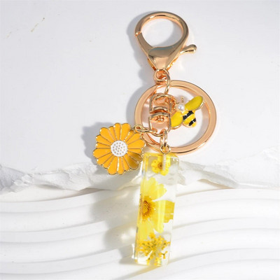 Χαριτωμένο τεχνητό μενταγιόν μαργαριτάρι μελισσών 26 γράμματα Μπρελόκ Μόδα μαργαρίτα με λουλούδι μπρελόκ με ρητίνη Γυναικεία ανδρική τσάντα αυτοκινήτου Γραφικό στοιχείο τηλεφώνου
