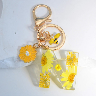 Χαριτωμένο τεχνητό μενταγιόν μαργαριτάρι μελισσών 26 γράμματα Μπρελόκ Μόδα μαργαρίτα με λουλούδι μπρελόκ με ρητίνη Γυναικεία ανδρική τσάντα αυτοκινήτου Γραφικό στοιχείο τηλεφώνου