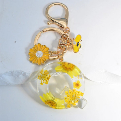 Χαριτωμένο τεχνητό μενταγιόν μαργαριτάρι μελισσών 26 γράμματα Μπρελόκ Μόδα μαργαρίτα με λουλούδι μπρελόκ με ρητίνη Γυναικεία ανδρική τσάντα αυτοκινήτου Γραφικό στοιχείο τηλεφώνου