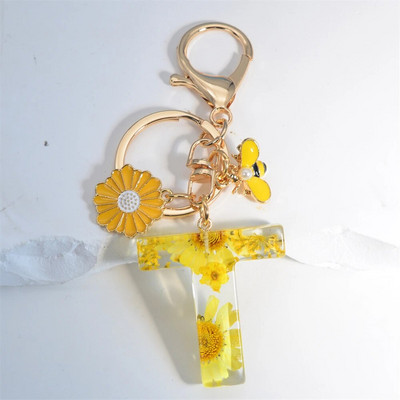 Χαριτωμένο τεχνητό μενταγιόν μαργαριτάρι μελισσών 26 γράμματα Μπρελόκ Μόδα μαργαρίτα με λουλούδι μπρελόκ με ρητίνη Γυναικεία ανδρική τσάντα αυτοκινήτου Γραφικό στοιχείο τηλεφώνου