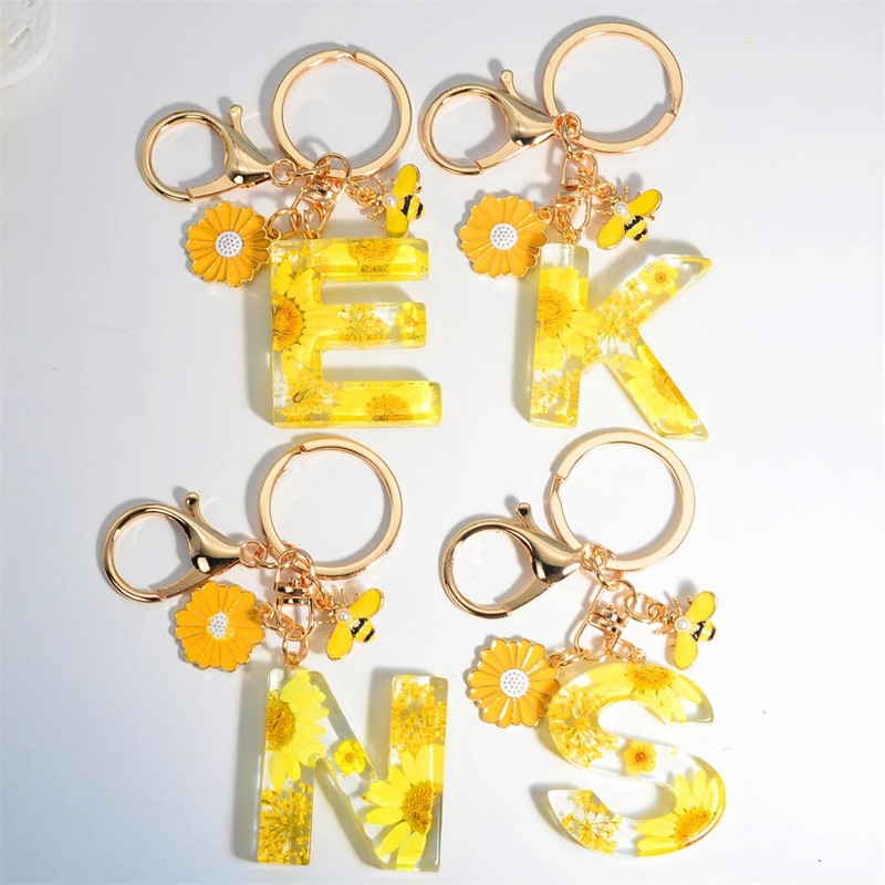 Χαριτωμένο τεχνητό μενταγιόν μαργαριτάρι μελισσών 26 γράμματα Μπρελόκ Μόδα μαργαρίτα με λουλούδι μπρελόκ με ρητίνη Γυναικεία ανδρική τσάντα αυτοκινήτου Γραφικό στοιχείο τηλεφώνου