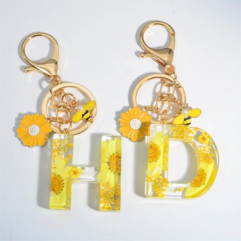 Χαριτωμένο τεχνητό μενταγιόν μαργαριτάρι μελισσών 26 γράμματα Μπρελόκ Μόδα μαργαρίτα με λουλούδι μπρελόκ με ρητίνη Γυναικεία ανδρική τσάντα αυτοκινήτου Γραφικό στοιχείο τηλεφώνου