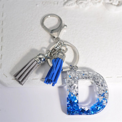 Radoši 26 burtu sveķu atslēgu piekariņi ar pušķi.