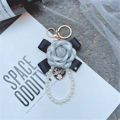 Luksusa melna kamēlija īstas ādas ziedu atslēgu piekariņš vēstule Lietussarga kulons automašīnas atslēgu piekariņa gredzena piekariņš somai