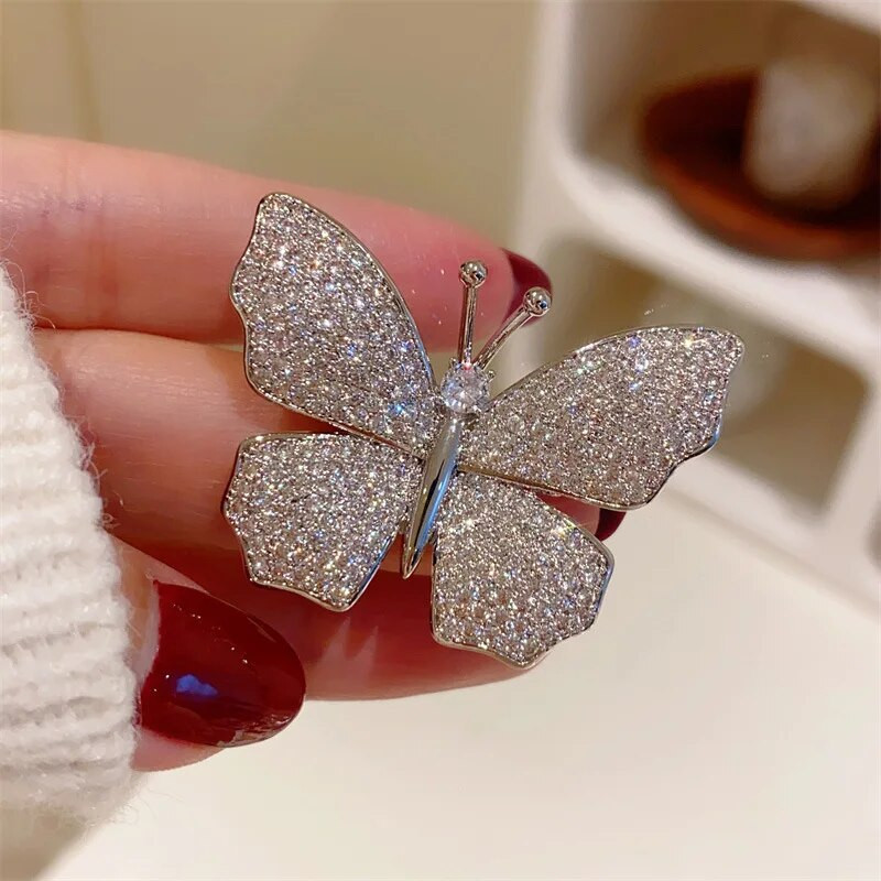 Rhinestone tauriņu saktas sievietēm sudraba krāsā, grezns dizains augstas kvalitātes kukaiņu atloka piespraudes Sieviešu mētelis korsāža kāzu dāvana