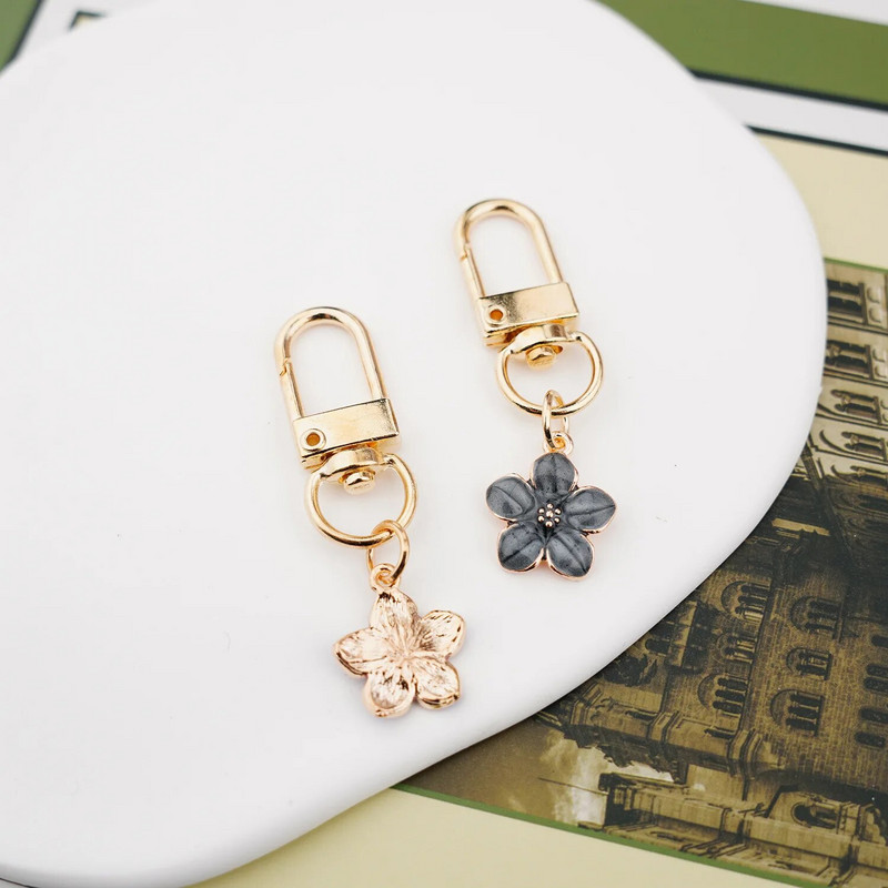 Skaists Sakura ziedu atslēgu piekariņš, emalja violets zaļš rozā balts melns sieviešu atslēgu piekariņš