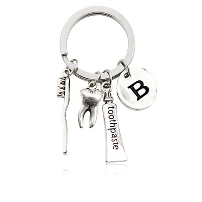 Radoša personība 26 vēstules ar zobu birstes zobu pastu Atslēgu piekariņš Zobi Veselības aizsardzības izpratne Piemiņas rotaslietas