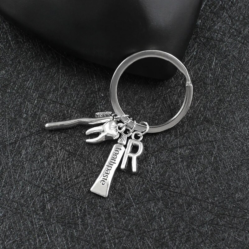 Radoša personība 26 vēstules ar zobu birstes zobu pastu Atslēgu piekariņš Zobi Veselības aizsardzības izpratne Piemiņas rotaslietas