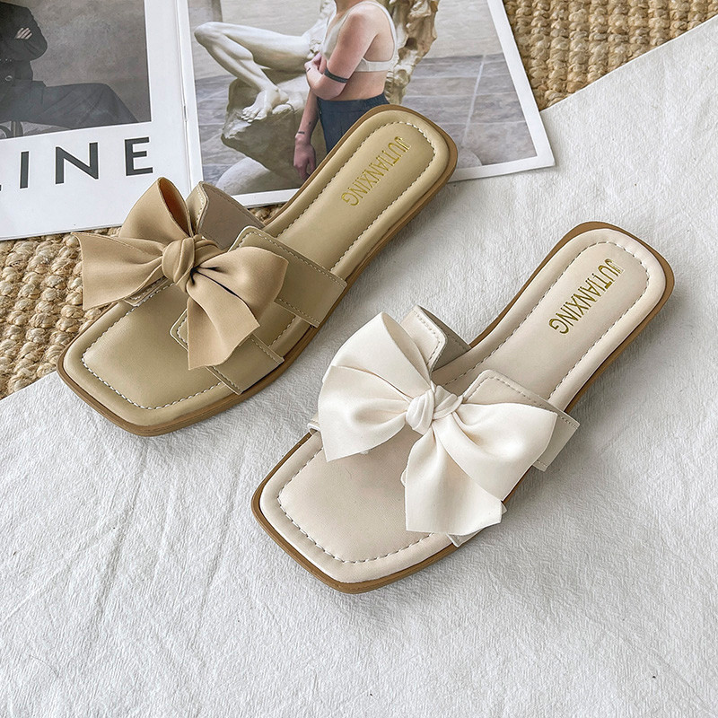 Suvised suured sussid naistele, lamedad 2023. aasta uued ühevärvilised tippklassi haldjastiilis naiste vibu sandaalid, PU