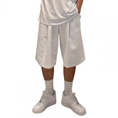 Muške kratke hlače s elastičnim strukom Elegantne muške kratke hlače s elastičnom vezom u struku, širokim dizajnom nogavica, džepovima za fitness