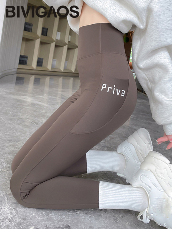 BIVIGAOS Pavasara vasara Jauni sieviešu sānu kabatas burtu legingi haizivīdas legingi ar augstu vidukli Skinny Slim sporta skriešanas fitnesa legingi