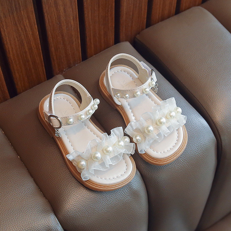 Uus suvise stiiliga moodsad mugavad ja vabaaja lameda tallaga helmestega ühe rihmaga libisemiskindlad lahtise varbaga tüdrukute kulumiskindlad sandaalid