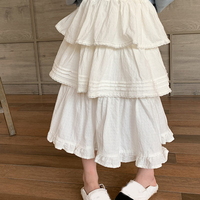 2024. gada pavasara meitenes daudzpusīgi balti svārki korejiešu stila rudens princeses slāņaini mežģīņu malas žakarda kūkas svārki vidēja garuma