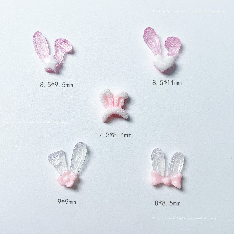 50 db Sötétben világító Kawaii Rabbit Ears Designs Köröm Gyanta Drágakövek Kövek Rózsaszín Aranyos Egyedi Design Bűbáj Ékszerek Körömhöz