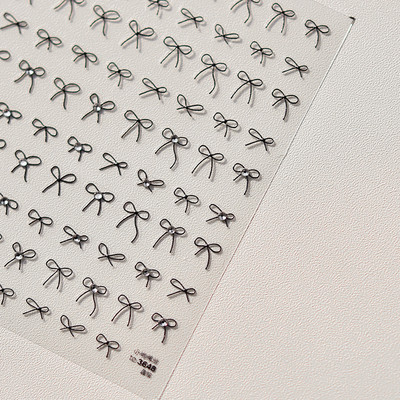 1gab 3D plānas melnbaltas mazas bantītes lentes bantes nagu uzlīmes Augstas kvalitātes līmējošās uzlīmes nagu mākslas apdare T-3604